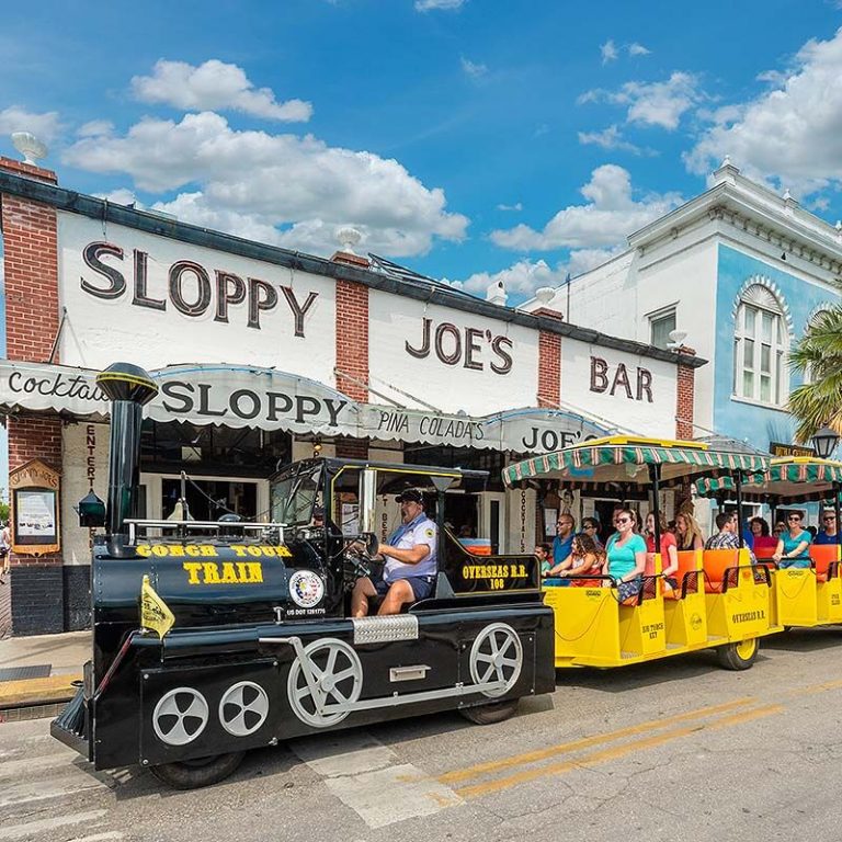 conch tour train driving past Sloppy Joes